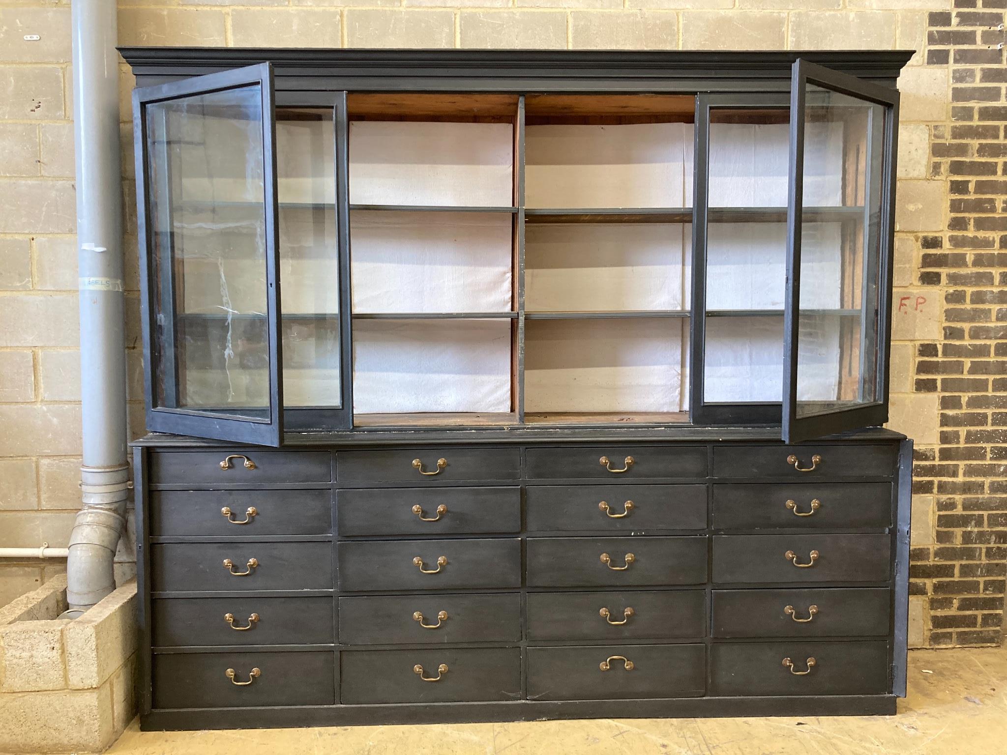 A Victorian painted pine glazed cabinet fitted twenty drawers, by repute The Bible Cabinet from Westminster Abbey, length 280cm, depth 54cm, height 244cm